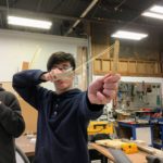 Will carefully aims his White Whings paper plane as Ewan looks on. Making Things Fly camp, December, 2018